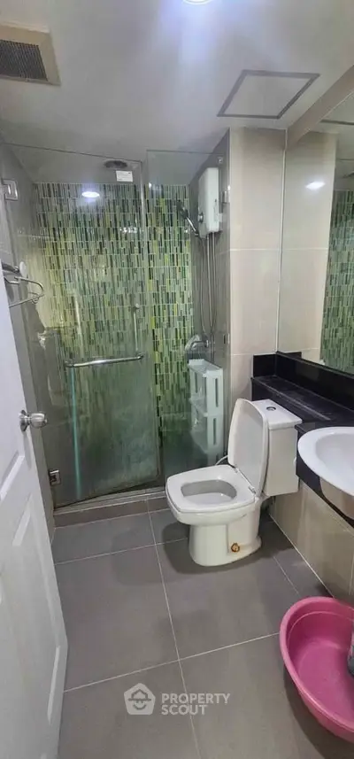 Modern bathroom with glass shower and sleek tile design