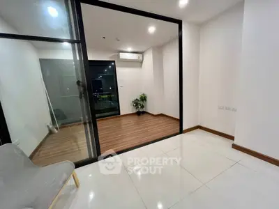 Modern apartment interior with sliding glass doors and sleek flooring