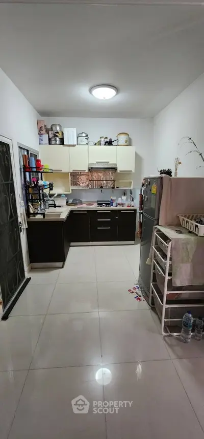 Modern kitchen with sleek cabinets and stainless steel appliances in a cozy apartment.
