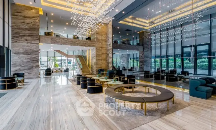 Luxurious modern lobby with elegant seating and stunning lighting fixtures.