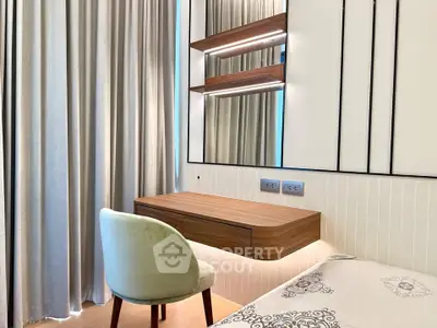 Modern bedroom with elegant floating desk and plush chair, featuring stylish decor and soft lighting.