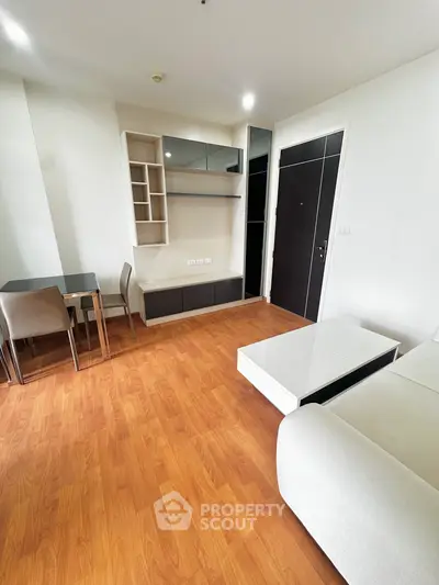 Modern living room with wooden flooring and sleek furniture