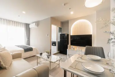 Modern studio apartment with open layout, featuring cozy living area, stylish kitchen, and elegant bedroom.
