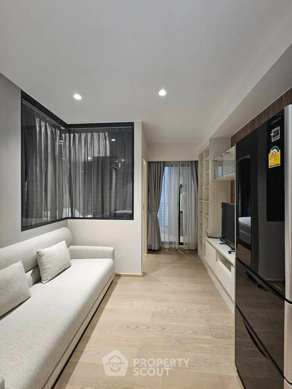 Modern living room with sleek design and large windows in a contemporary apartment.