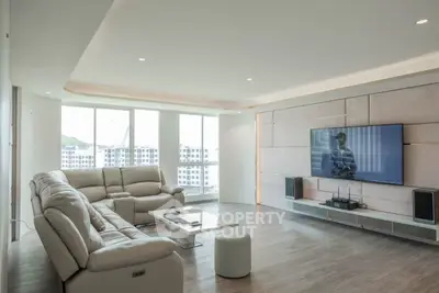 Spacious modern living room with large windows and stylish furniture