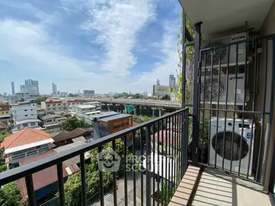 Spacious balcony with city view and laundry area in modern apartment