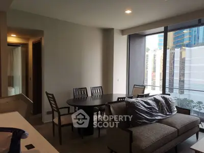 Modern living room with dining area and large windows in urban apartment