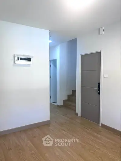 Modern interior with wooden flooring and staircase in a minimalist home