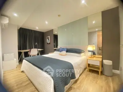 Spacious modern bedroom with elegant decor and ample natural light
