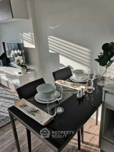 Modern dining area with elegant table setting and stylish decor in a contemporary apartment.