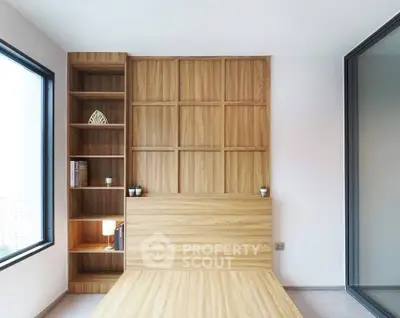 Modern minimalist bedroom with wooden paneling and built-in shelving.