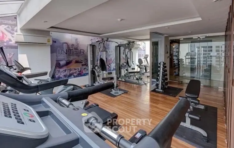 Modern gym with state-of-the-art equipment in a luxury residential building.
