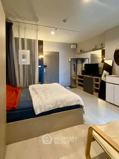 Modern bedroom with stylish decor and cozy ambiance, featuring a comfortable bed and sleek furniture.
