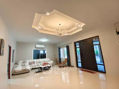 Spacious living room with elegant ceiling design and modern decor