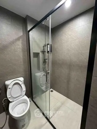 Modern bathroom with glass shower enclosure and sleek tile design