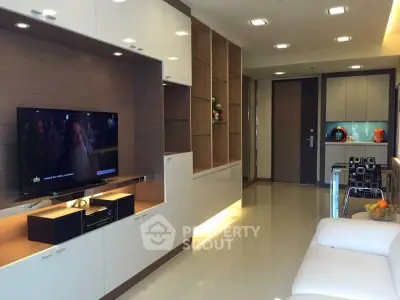 Modern living room with sleek entertainment unit and cozy seating area