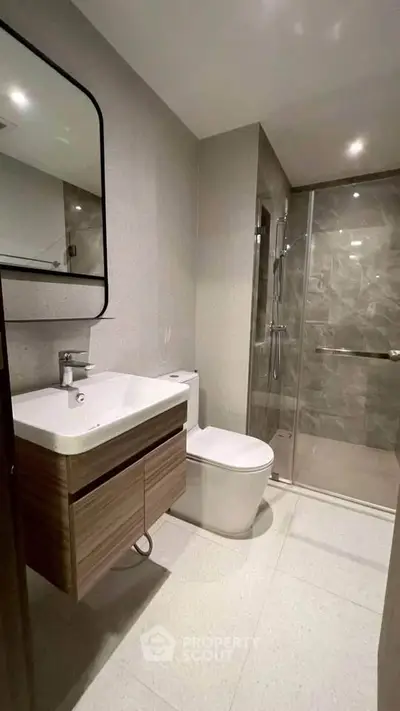 Modern bathroom with sleek fixtures and glass shower enclosure