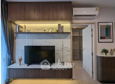 Modern living room with stylish TV unit and air conditioning in a cozy apartment.