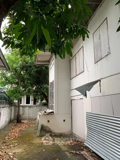 Explore potential with this fixer-upper property featuring spacious outdoor area and lush greenery.