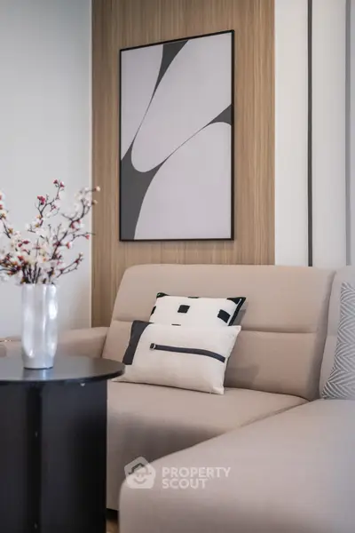 Modern living room with stylish sofa and abstract art, perfect for contemporary urban living.