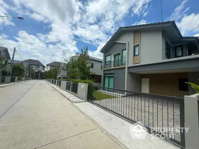 Modern two-story house with spacious driveway in suburban neighborhood