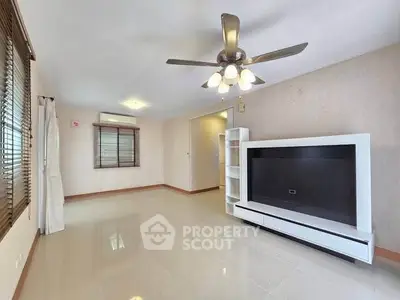 Spacious living room with modern ceiling fan and sleek TV unit, perfect for relaxation and entertainment.