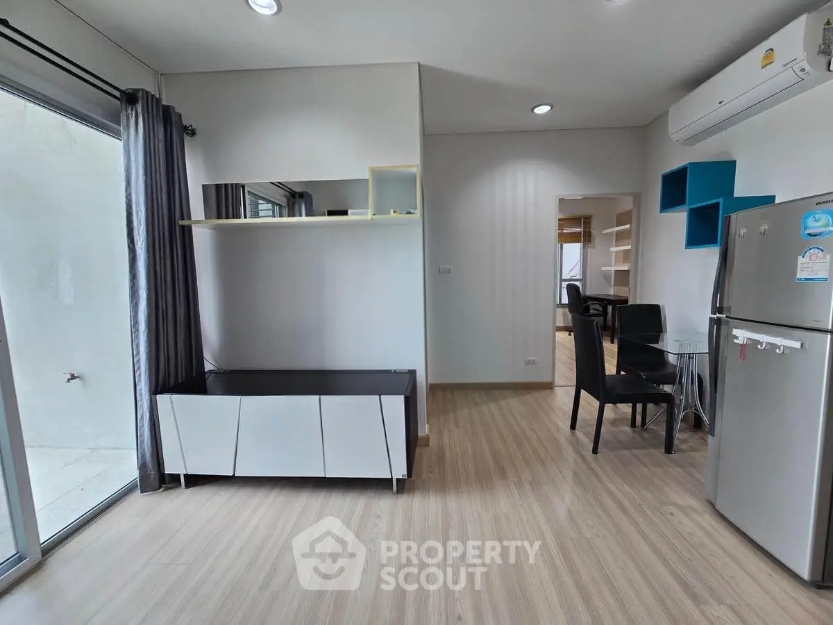Modern apartment interior with sleek furniture and air conditioning, featuring a bright and open living space.