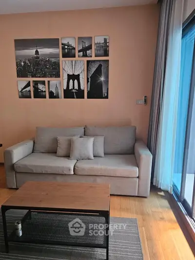 Modern living room with stylish decor and large window for natural light.