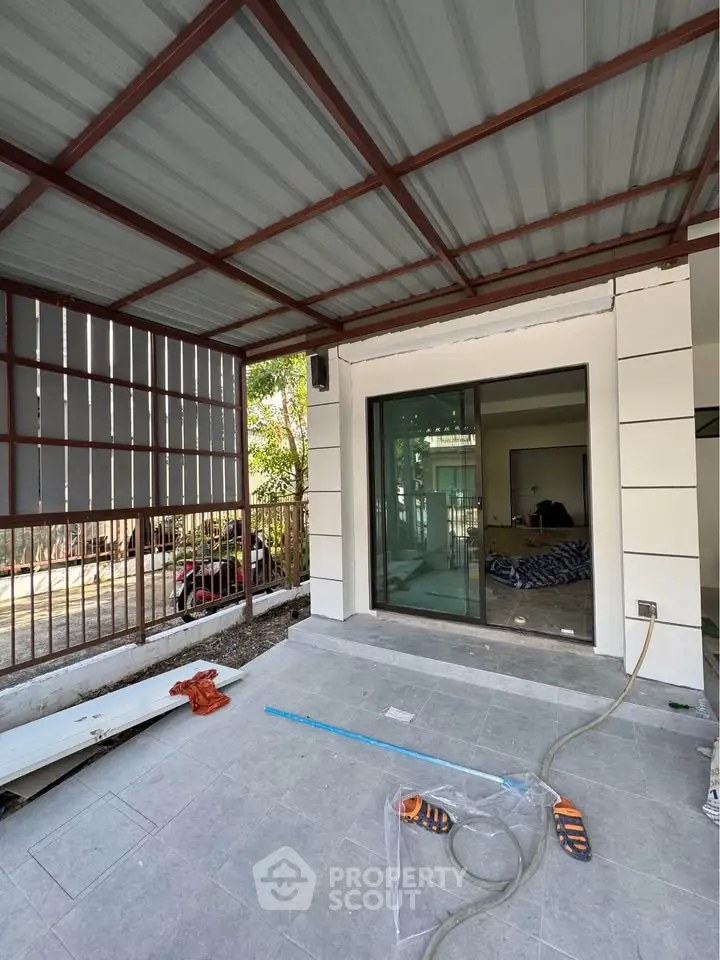 Spacious covered patio with sliding glass doors and modern design.
