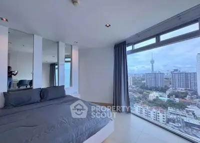 Spacious bedroom with stunning city view and modern decor