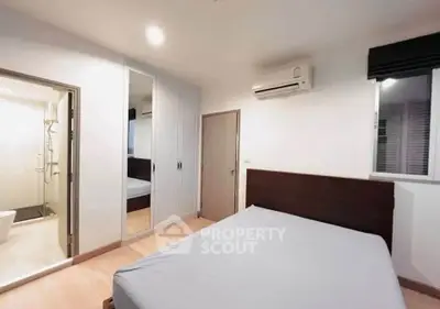 Modern bedroom with ensuite bathroom and air conditioning