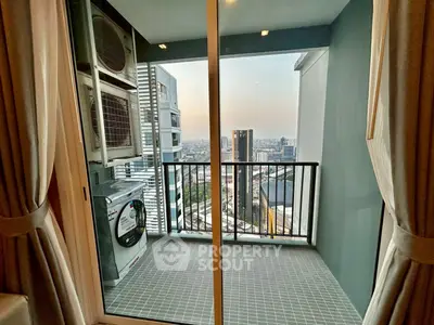 Modern balcony with city view and laundry appliances in high-rise apartment