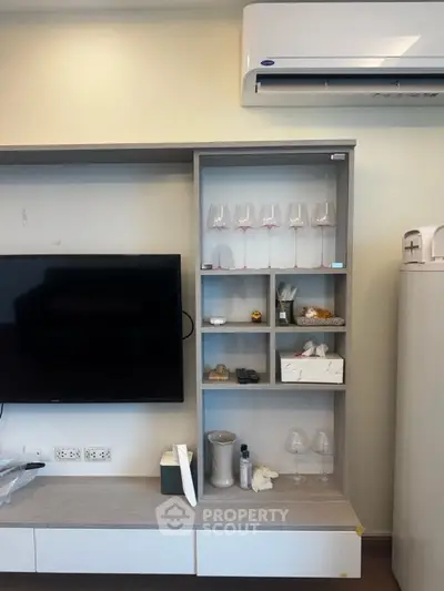 Modern living room with wall-mounted TV and air conditioning unit