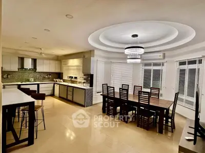 Spacious modern kitchen with dining area and elegant lighting