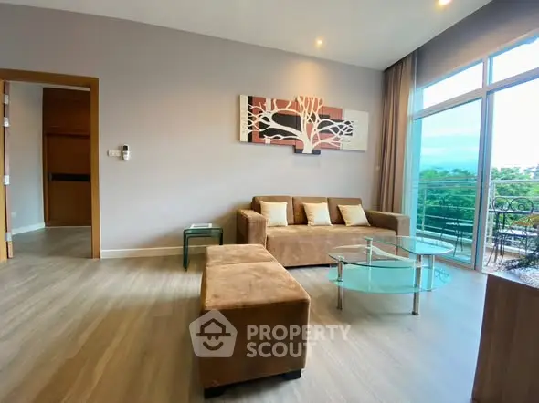 Spacious living room with modern decor and large windows offering a scenic view.