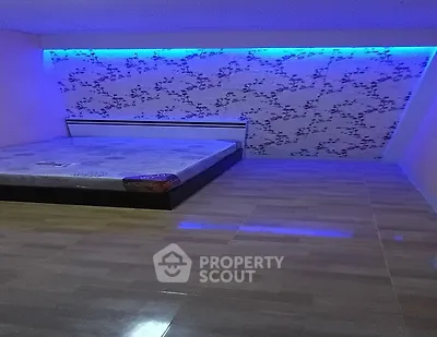 Modern bedroom with unique lighting and floral accent wall