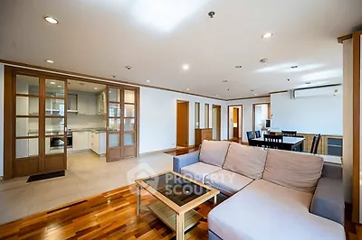 Spacious open-plan living room with modern kitchen and dining area.