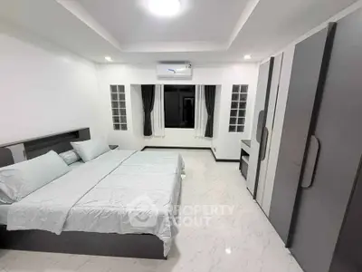Spacious modern bedroom with sleek design and ample natural light