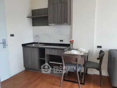 Modern compact kitchen with dining area in stylish apartment