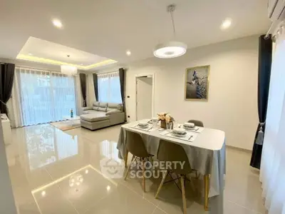 Spacious modern living and dining area with elegant decor and natural light.