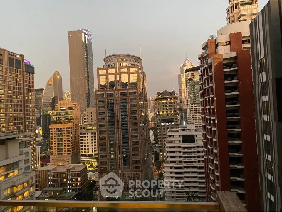Stunning cityscape view from a high-rise balcony showcasing modern skyscrapers at dusk.