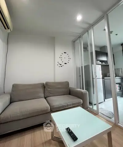 Modern living room with glass partition and compact kitchen