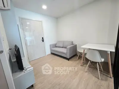 Modern living room with cozy sofa and dining area in a stylish apartment.
