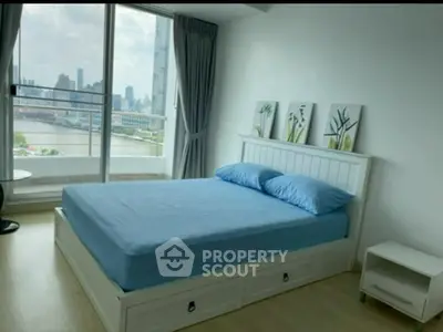 Modern bedroom with city view and stylish decor in high-rise apartment.
