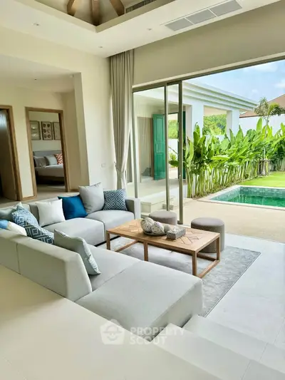 Luxurious living room with pool view and modern decor in tropical villa