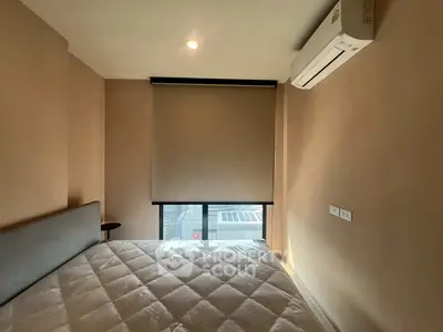 Cozy bedroom with modern air conditioning and large window view