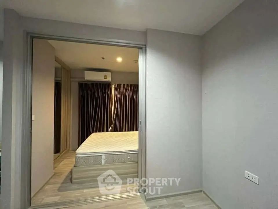 Modern bedroom with sliding doors and minimalist design in a stylish apartment.