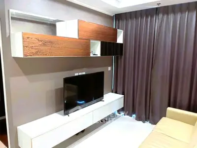 Modern living room with sleek TV unit and stylish curtains