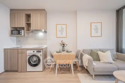 Modern open-plan kitchen and living area with stylish decor and integrated appliances.