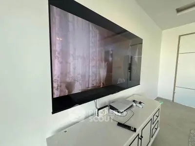Modern living room with wall-mounted TV and sleek console